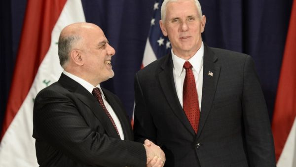 This file photo taken on February 18, 2017 shows US Vice President Michael Richard Pence (R) and Iraq's Prime Minister Haider Al-Abadi as they shake hands in Munich, southern Germany. (AFP/Thomas Kienzle)