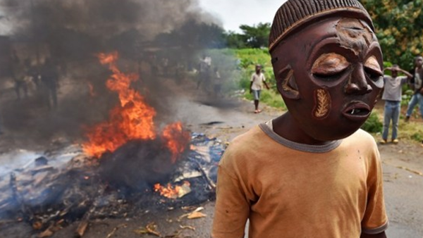 A protester wears a mask in a demonstration against Pierre Nkurunziza in 2015 (AFP/FILE)