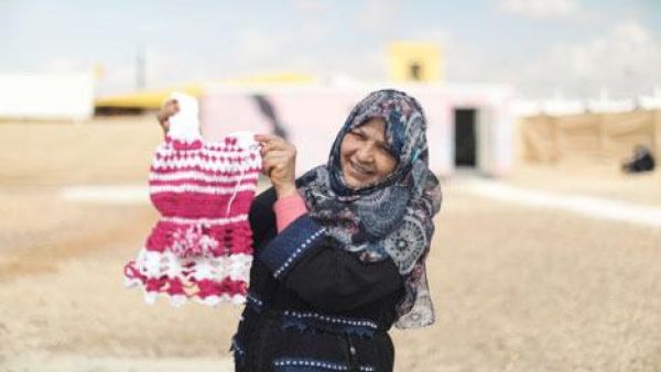 An Azraq camp resident stands in front of a newly-opened centre for women (Photo courtesy of the Danish Refugee Council)