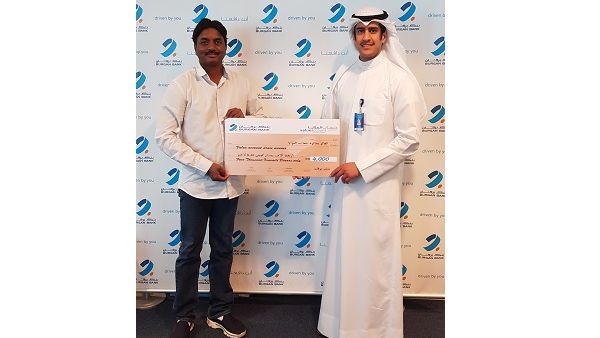 Chandra Sekhar Gembal, winner of the KD4,000 draw, receiving his cheque. 