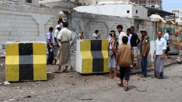 People gather at the site of a car bombing near the Foreign Ministry in Aden on Friday. (AFP/Saleh Al-Obeidi)