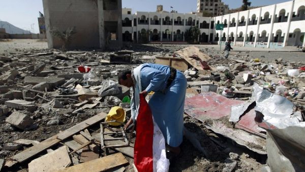 A man walks through the rubble of a school after an airstrike in Sanaa, Yemen, in February. (AFP/Muhammed Huwais)