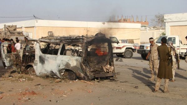 Yemenis check a burning vehicle following a reported suicide car bombing in Huta, the capital of the southern province of Lahj, a bastion of Al-Qaeda militants, on March 27, 2017. (AFP/Saleh al-Obeidi)