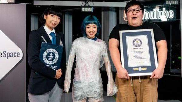 A Japanese YouTuber wrapped a singer from her feet to her shoulders in cling wrap to set a new world record. ( Guinness World Records)