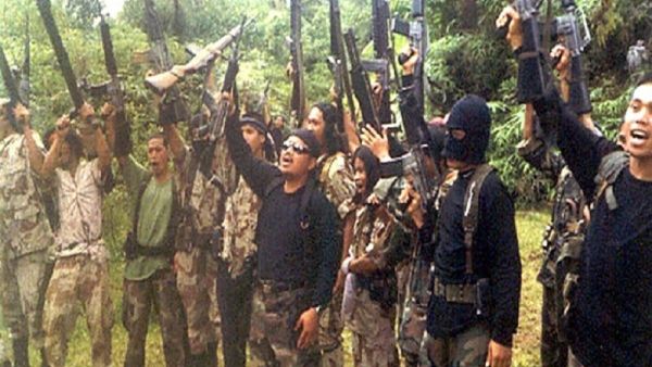 Abu Sayyaf militants raise their weapons. (AFP/File) Abu Sayyaf militants raise their weapons. (AFP/File)