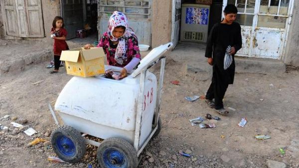 An eight-year-old Afghan girl stocks her ice cream cart. She is one of thousands of Afghan children providing for their families. (AFP/File) An eight-year-old Afghan girl stocks her ice cream cart. She is one of thousands of Afghan children providing for their families. (AFP/File)