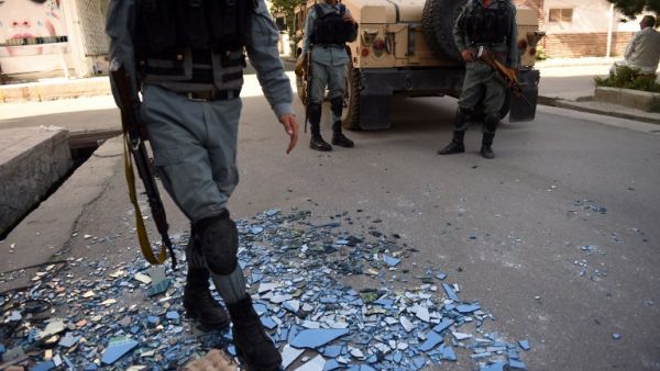 Afghan security forces outside the site of an attack on Care International in Kabul on September 6, 2016. (AFP/Walik Kohsar)