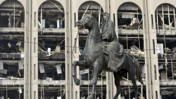 Iraqi King Faisal rides his horse outside government buildings in Baghdad, damaged in a 2009 suicide bombing.  (AFP/Ahmad al-Rubaye)