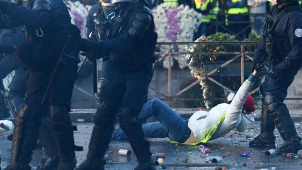 A policeman evacuates a demonstrator in Quimper, western France, during a nationwide day of protest. (AFP)