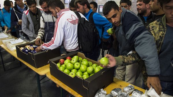 Refugees receive food in Germany, and Alex Assali wanted to give back to the German people for their hospitality. (AFP/File)