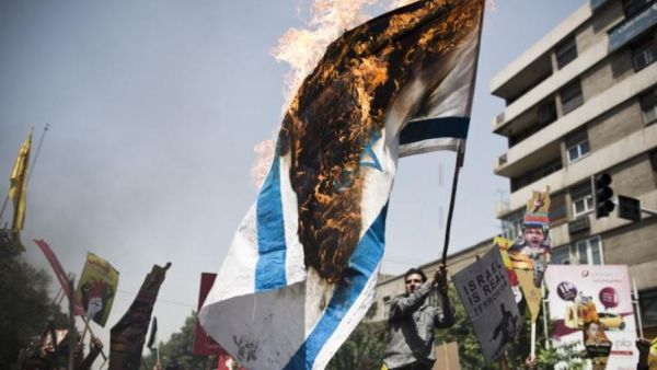 File photo of an Israeli flag burning. (AFP/File)
