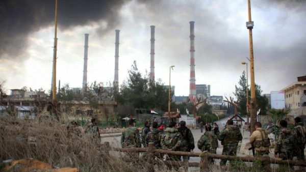 Smoke rises over Aleppo after an airstrike on militants in February. (AFP/File)
