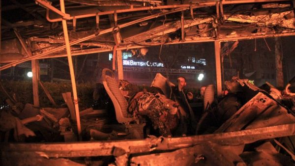 A man looks into a burnt-out bus at the site of a blast in Ankara on March 13, 2016. (AFP/Mehmet Ozer)