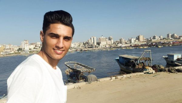 Assaf poses with the beautiful Port of Gaza behind him. (Facebook)