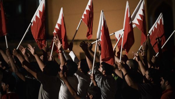 Protesters hold Bahraini flags. (AFP/File)