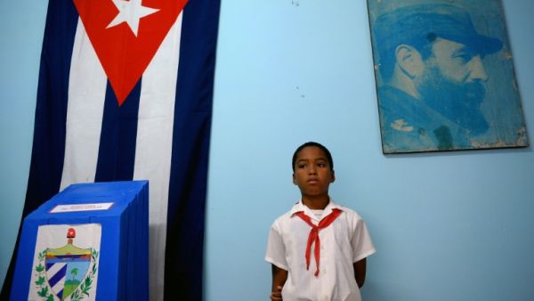 A schoolboy stands at a polling station in Havana during elections (AFP/File Photo)