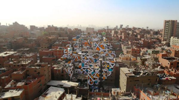 The French-Tunisian street artist eL Seed's latest work is a massive mural covering more than 40 buildings in Cairo's Garbage City. (Instagram)