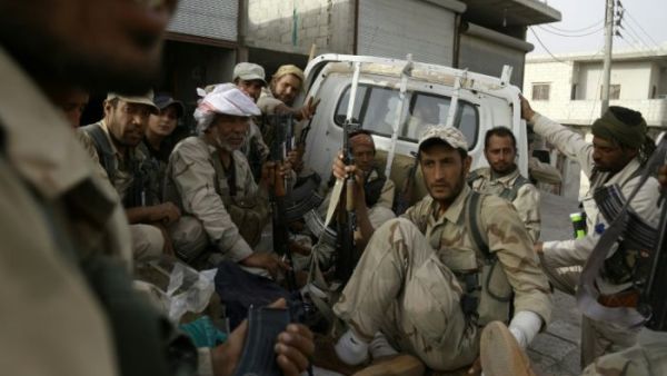 Fighters from Syria's Manbij military council sit in a truck on the outskirts of the northern town of Manbij before another battle with Daesh militants. (AFP/File)