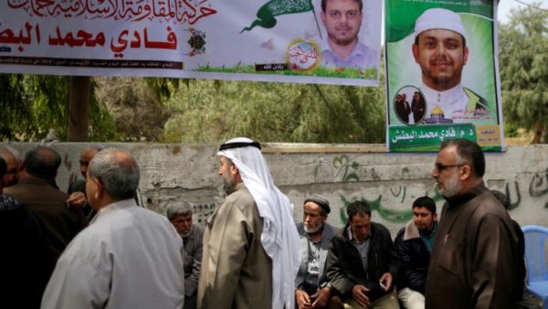 Palestinians gather in mourning outside the family home of 35-year-old professor and Hamas member Fadi Mohammad al-Batsh (AFP/File Photo)	