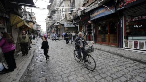 A man rides his bicycle in Damascus.  Recently, people in Damascus have been turning to bikes amidst heavy traffic and soaring transportation costs.  (AFP/Joseph Eid)