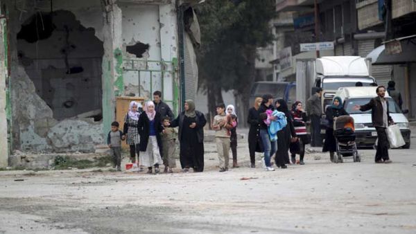 People walked through a bombed street in Daraa. (AFP/File)