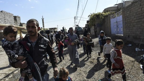 Families flee the Gogjali district of Mosul (Bulent Kilic/AFP)