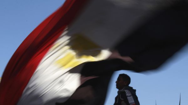 A demonstrator waves the Egyptian flag in Cairo's Tahrir Square on January 25, 2012, to mark the first anniversary of Egypt's uprising. (AFP/File)