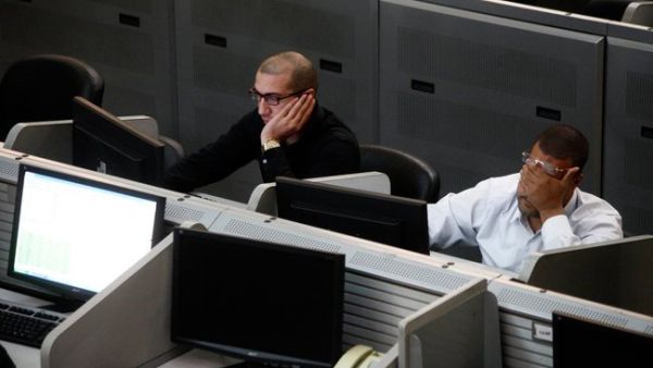 Traders working at the Egyptian stock exchange in Cairo. (AFP)