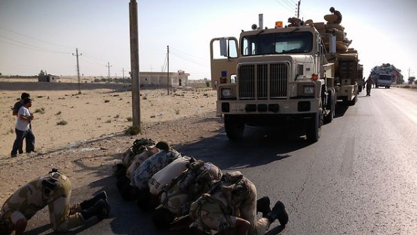 Egyptian officers stop to pray in front of a convoy truck during operations in North Sinai. (AFP/File)