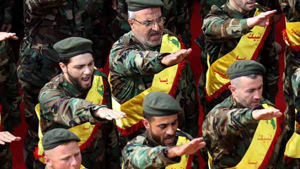 Hezbollah fighters salute during funeral for comrades. (AFP/File Photo)