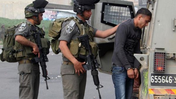 Palestinian protester being detained by IDF soldiers. (AFP/Jaafar Ashtiyeh)