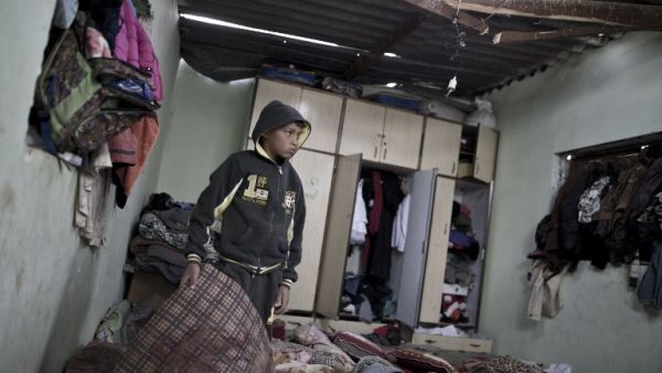 A Palestinian boy inspects a bedroom of the damaged Khussa family home after an Israeli strike on Hamas bases in Beit Lahiya, northern Gaza strip on March 12, 2016. (AFP/Mahmud Hams)