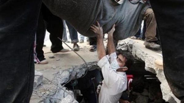 اشخاص ينتشلون جثة احد افراد عائلة السموني في غزة يوم 18 يناير كانون الثاني 2009. 
