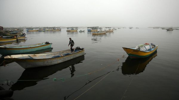 A Palestinian fisherman stands on his boat in Gaza City's seaport during heavy fog on February 26, 2017. (AFP/FILE) 