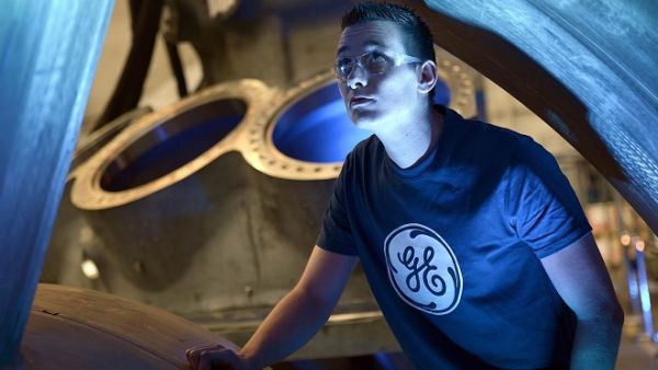 A worker looks at the 9HA Gas Turbine, at the General Electric (GE) plant in Belfort, France, on May 28, 2015. (AFP/ Frederick Florin)