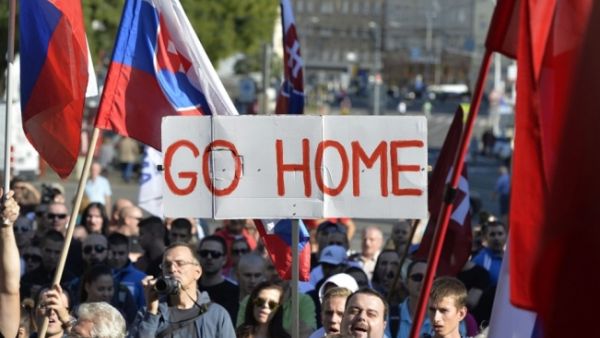 Participants hold flags and a banner during an anti-immigration rally organized by an initiative called "Stop Islamisation of Europe" and backed by the far-right "People's Party-Our Slovakia" on September 12, 2015 in Bratislava, Slovakia.  (AFP/Samuel Kubani)