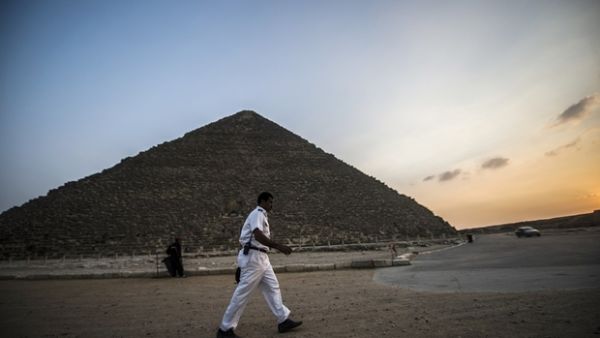 A policeman walks past the Great Pyramid at Giza (AFP/File Photo)	