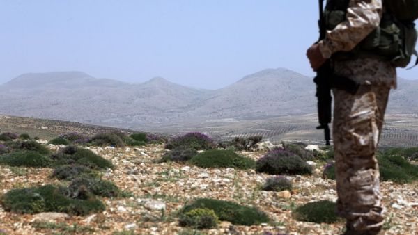 A Hezbollah fighter stands on a hill near the Lebanese-Syrian border of the Qalamun mountains. (AFP/Joseph Eid)