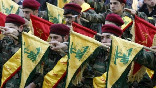 Members of Lebanon's Shia movement Hezbollah hold their flags during the funeral of a Hezbollah fighter, who was killed while fighting alongside Syrian government forces in Syria, March 1, 2016. (AFP/Mahmoud Zayyat)