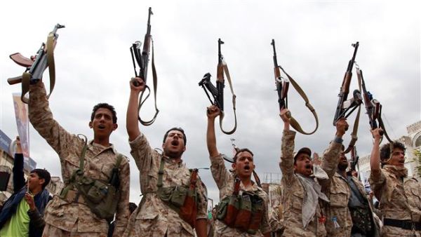 The fighters of the Houthi movement brandish their weapons during a rally against Saudi airstrikes. (AFP/File)