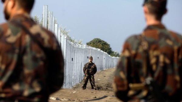 Hungarian soldiers stand guard at the border line between Serbia and Hungary near Roszke village on September 13, 2015. (AFP/Peter Kohalmi) Hungarian soldiers stand guard at the border line between Serbia and Hungary near Roszke village on September 13, 2015. (AFP/Peter Kohalmi)