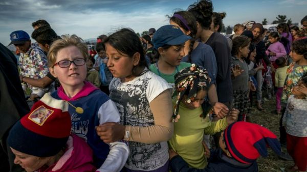 Children queue for food at the makeshift camp for migrants and refugees at the Greek-Macedonian border near the village of Idomeni on April 27, 2016. (AFP/Joe Klamar) Children queue for food at the makeshift camp for migrants and refugees at the Greek-Macedonian border near the village of Idomeni on April 27, 2016. (AFP/Joe Klamar)