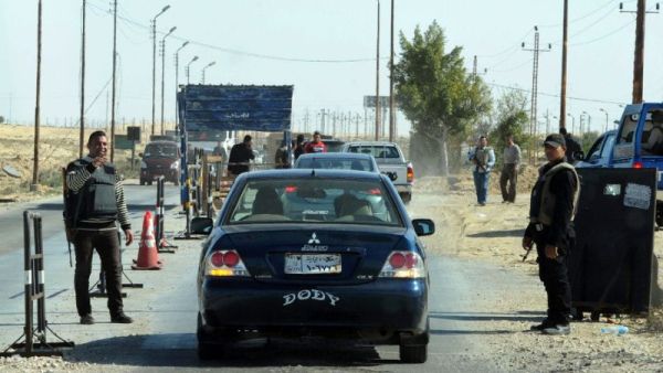 Egyptian police inspect cars at a checkpoint in North Sinai. (AFP/File)