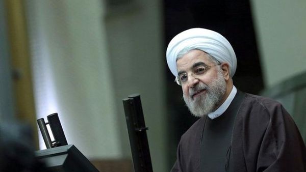 A handout picture released by the Iranian presidency shows the Islamic Republic's President Hassan Rouhani (R) delivering his speech to parliament/ [AFP]