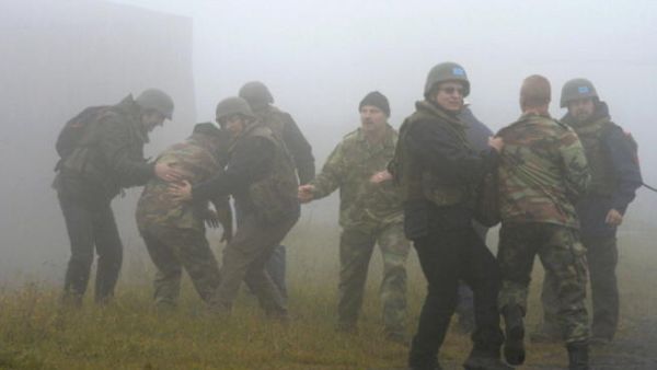 Apprentice chemical weapons inspectors of the United Nations and extras take part in an exercise during the education of OPCW inspectors at the German armed forces. [Getty Images]