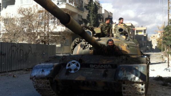 Syrian pro-government forces patrol in their tank in the town of Nabak near Damascus on December 7, 2013. [Getty Images]