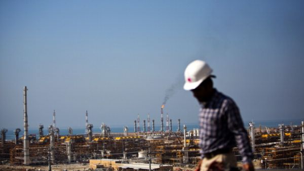 An Iranian worker walks near the phase 12 of the South Pars gas field facilities near the southern town of Kangan on the shore of the Gulf on Jan. 22, 2014. (AFP/Behrouz Mehri)