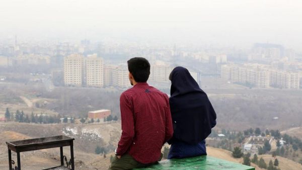 An Iranian couple looks out over Tehran in 2015.  (AFP/File)