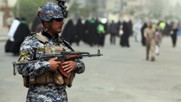 An Iraqi soldier stands guard on a main road in Baghdad as Shiite Muslim pilgrims arrive on June 2 (Ahamd al-Rubaye / AFP)
