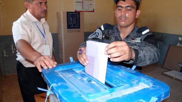 An Iraqi policeman casts his ballot in Ramadi on June 17, 2013 as security forces vote in provincial polls ahead of the rest of Iraqis in the Anbar province. Iraq held provincial elections in April except in six provinces, including Anbar and Nineveh, where polls were delayed because authorities said security could not be guaranteed (Azhar Shallal / AFP)